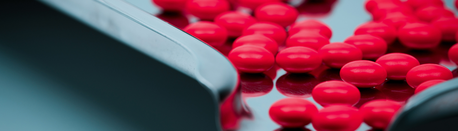 November Blog Image 2 VIew of red-coated tablets in a perforated coating pan